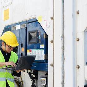 Technician monitoring cold chain logistics temperature following application of phase change materials